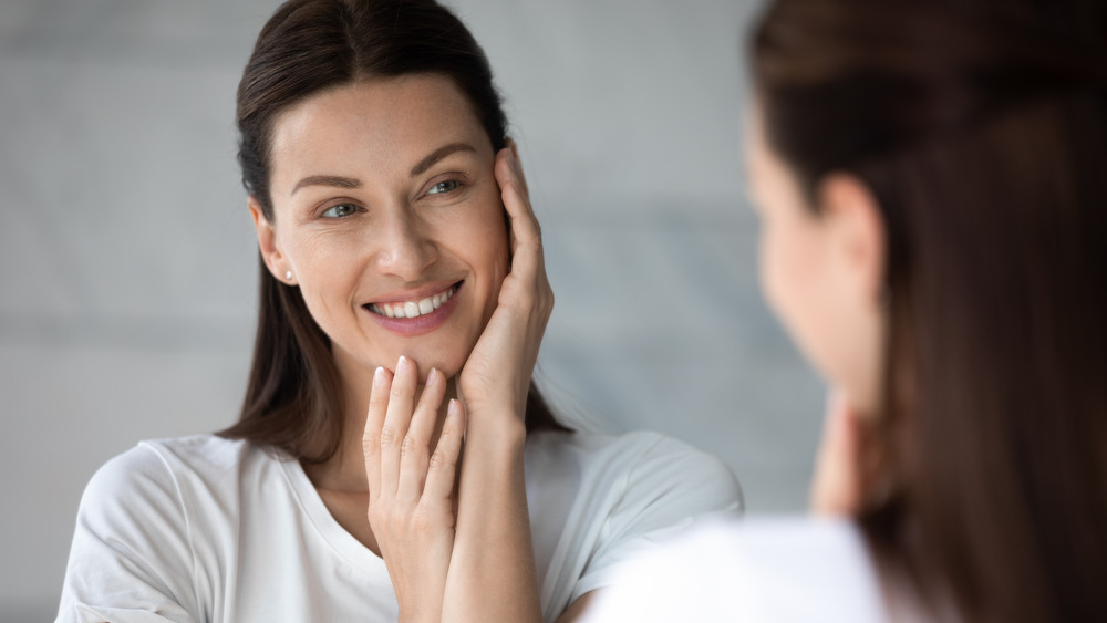 Woman looking in mirror