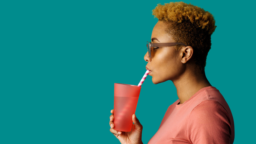 woman drinking water in place of soda