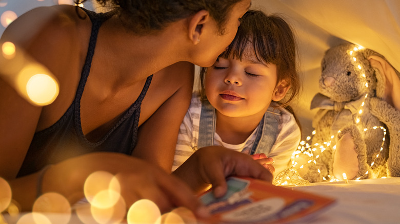 A young mom reading to her daughter 