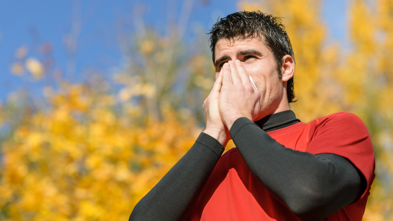 man blowing nose