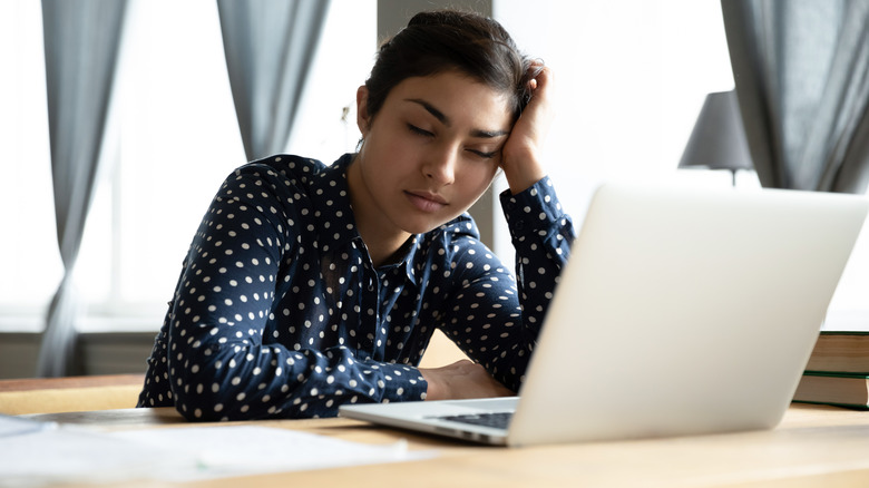 Tired woman on laptop