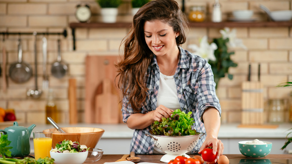 Happy woman at kitchen counter