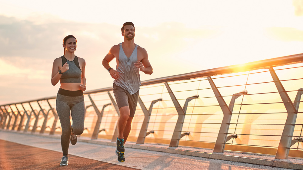 couple running on a bridge