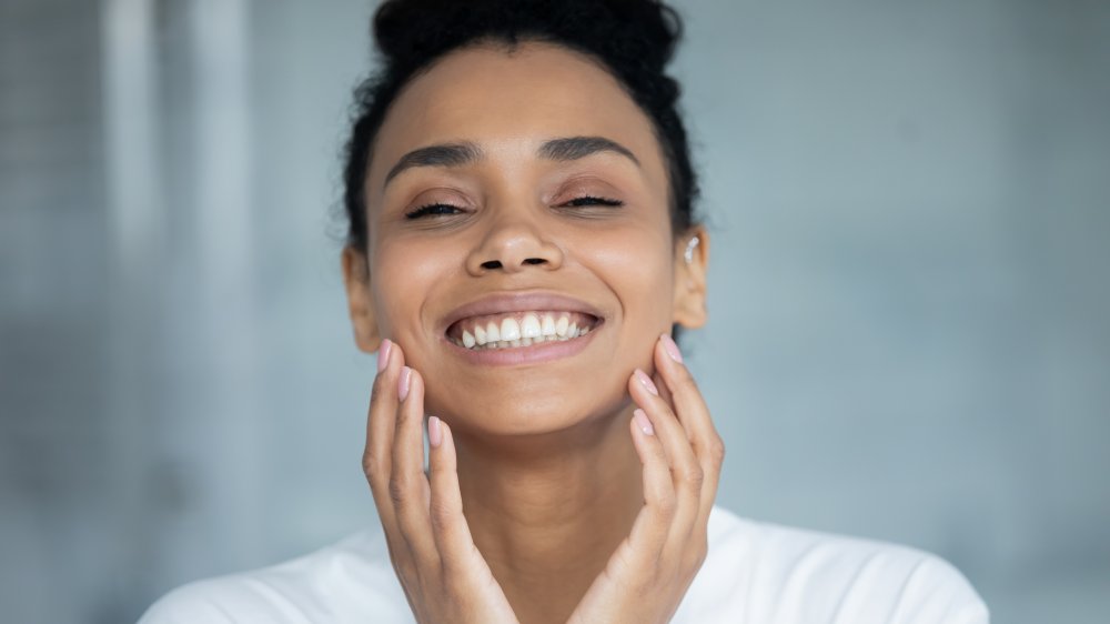 Woman touching her face