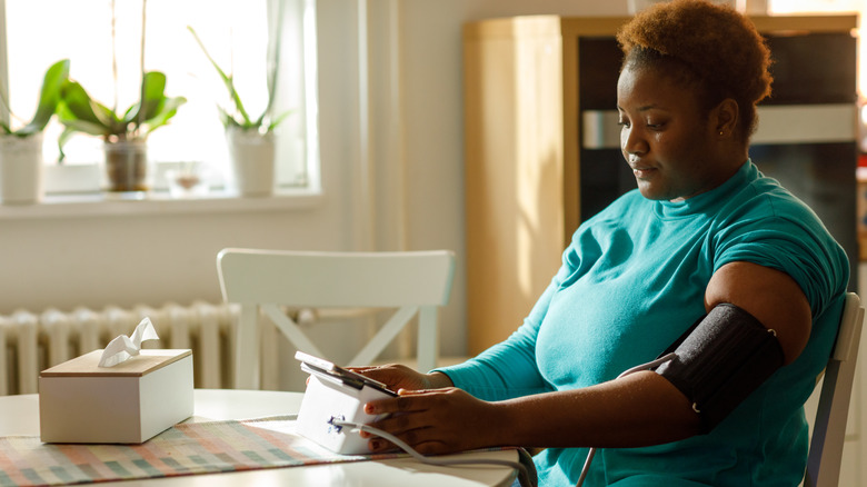 woman checking her blood pressure