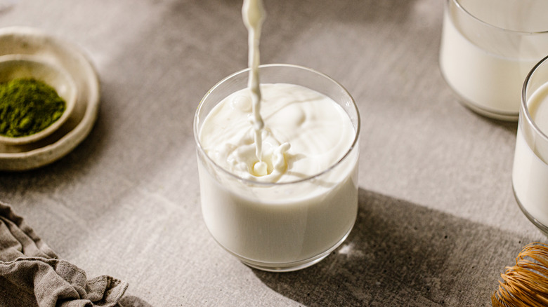 milk pouring into a small glass