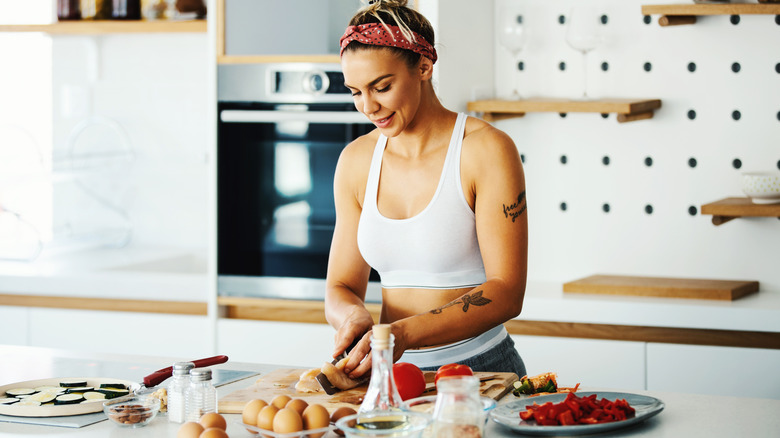 muscular woman prepping food
