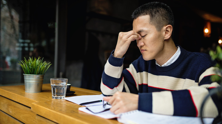Man having trouble concentrating while working