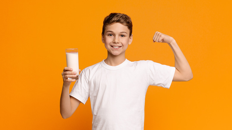 teen flexing with milk