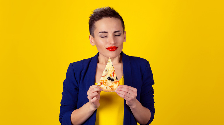 person with slice of pizza