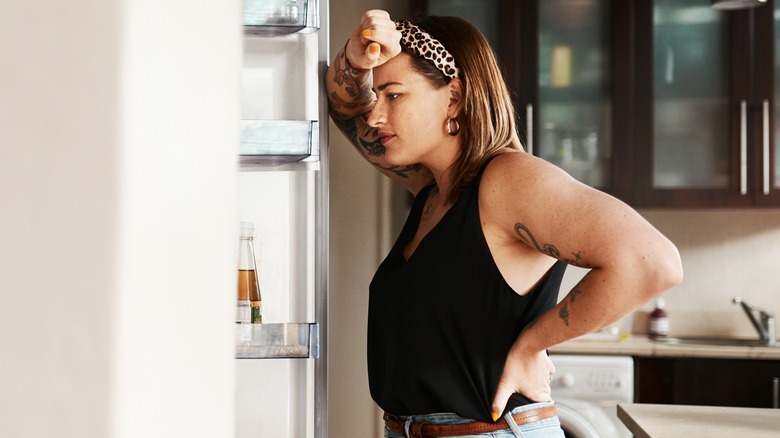 Woman looking in the fridge for something to eat