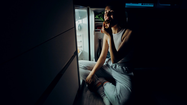 Woman eating sugar at night