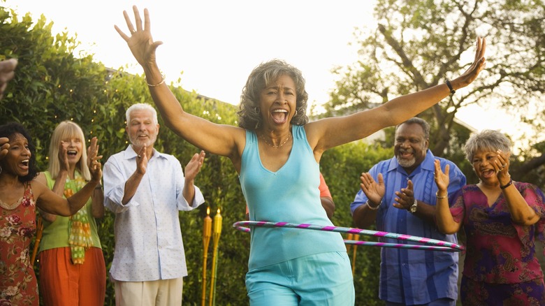 Middle-aged woman using hula hoop