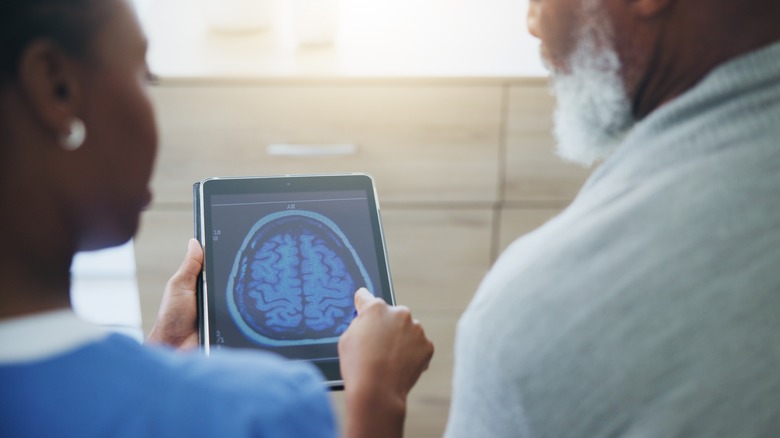 Doctor showing brain scan to patient