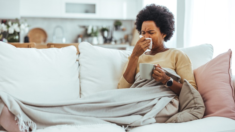 Sick woman lying on sofa