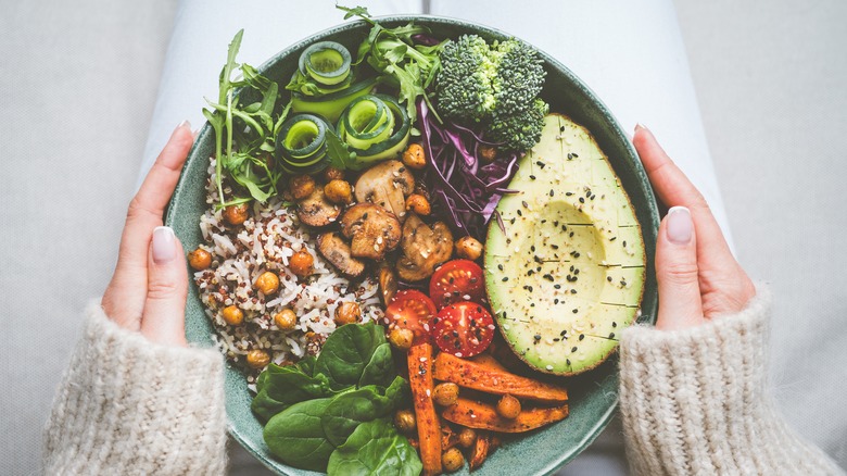 Woman holding a bowl filled with healthy vegetables