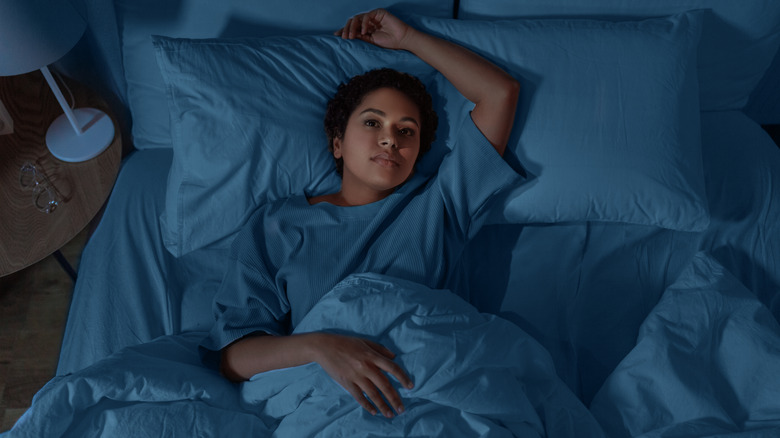 Woman lying awake in bed