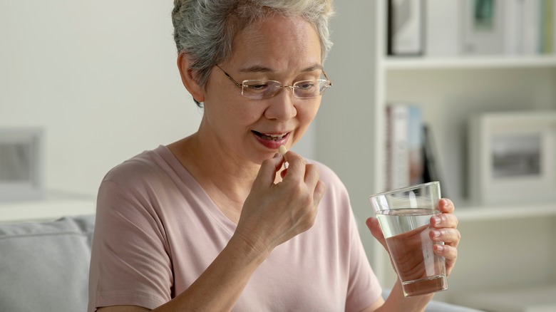 older woman taking medication