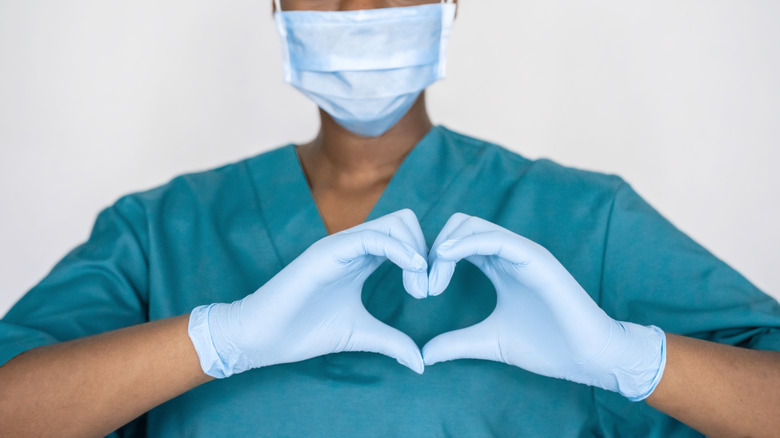 woman doing heart hands