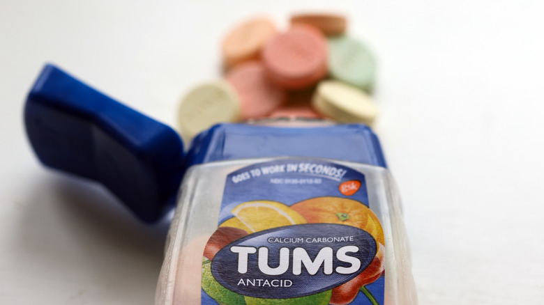 tums bottle with tablets spilling out