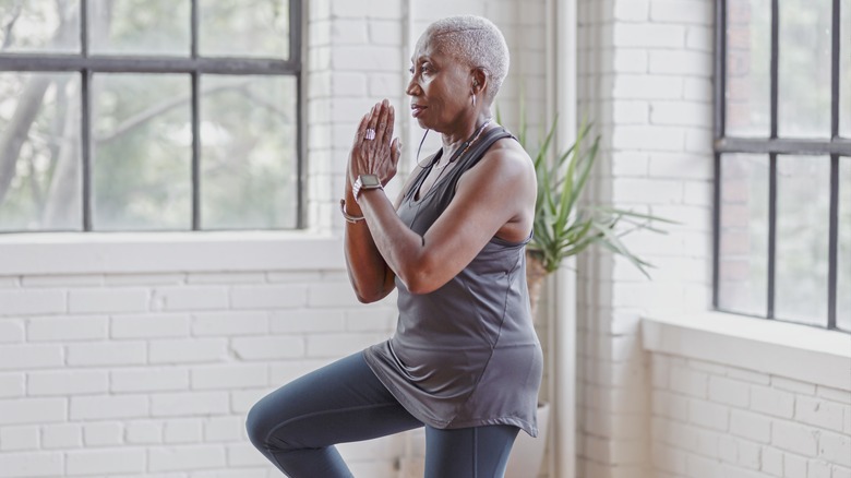 older woman practicing yoga