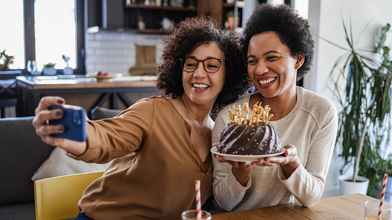 two women taking selfie and celebrating birthday