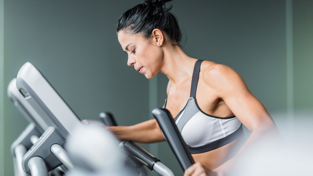 muscular woman on elliptical