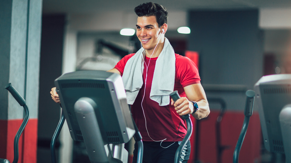 man smiling on elliptical