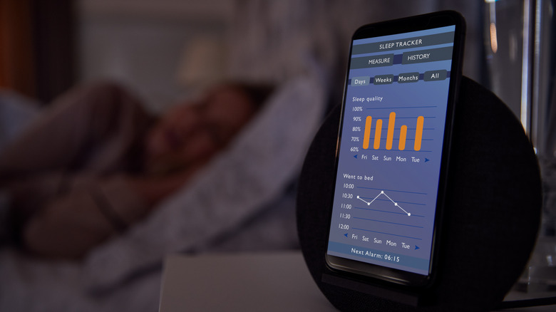 woman sleeping with a tracker next to her bed