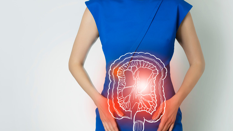 woman in a blue dress with a illustration of intestines overlaid indicating distress