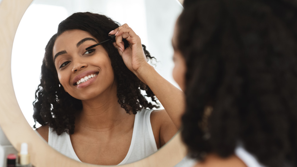 Woman applying mascara 