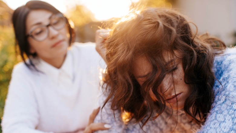 Sad woman being consoled by friend