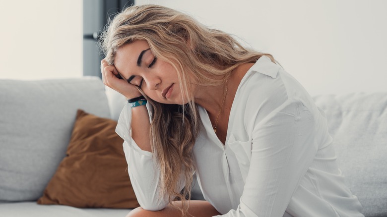 Young woman clutching her head