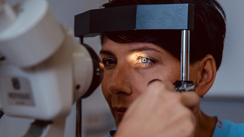 Short-haired woman getting eyes examined