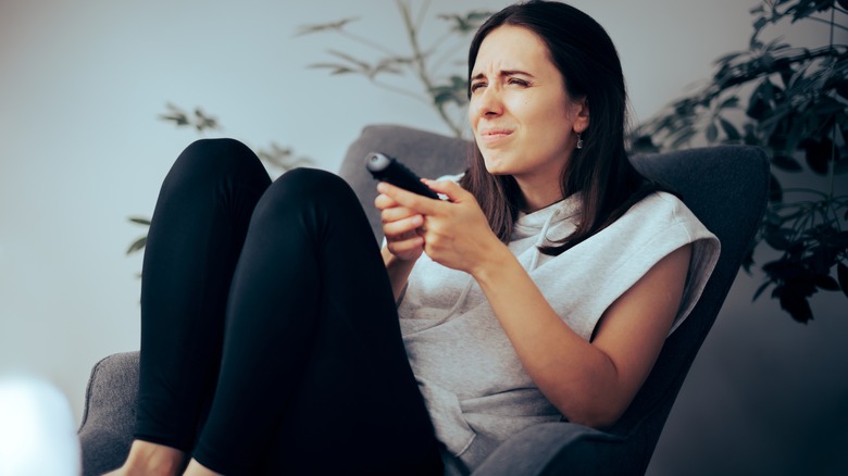 Woman squinting watching TV
