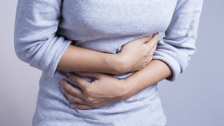 woman holding stomach