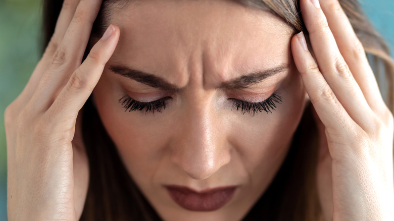 woman's headache makes her eyelashes longer