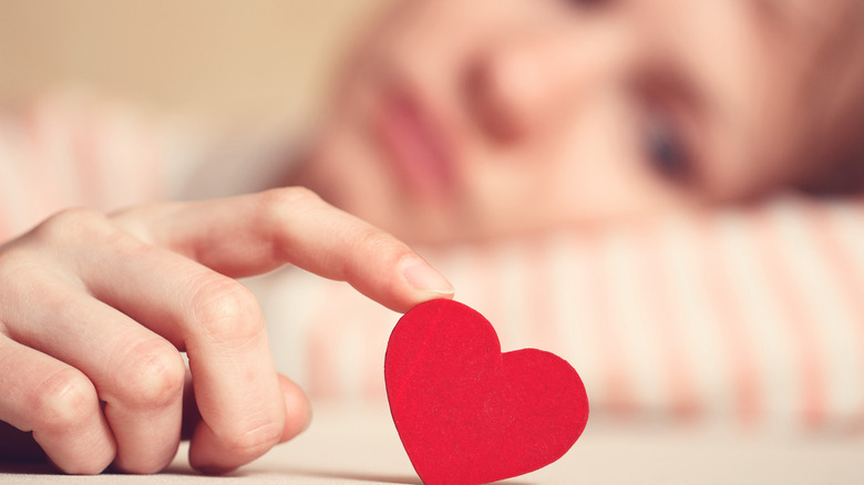 woman with paper heart for some reason