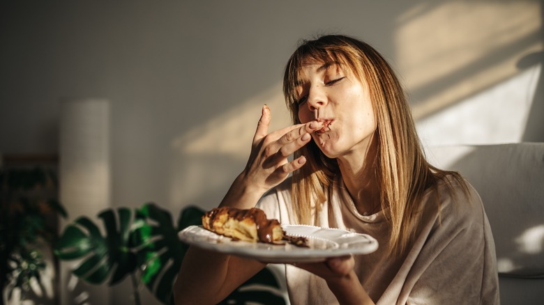 woman eating croissant