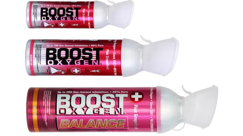 Three pink Boost Oxygen canisters