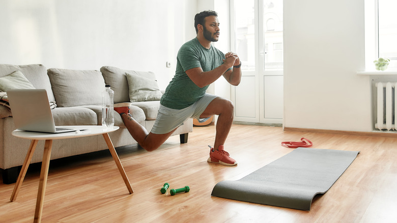 Indian man doing lunges at home