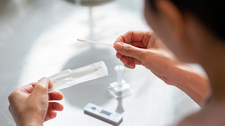 woman looking at rapid antigen results