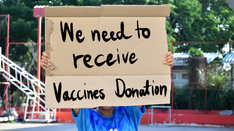 person in low-income country asking for vaccine donation