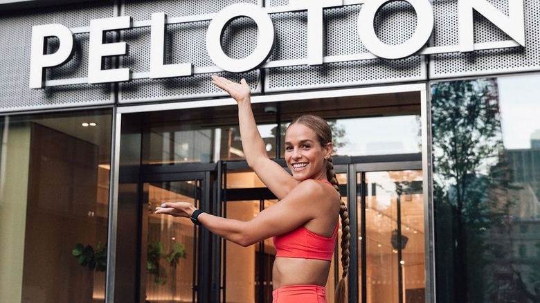 Jess Sims smiling in front of a Peloton store 