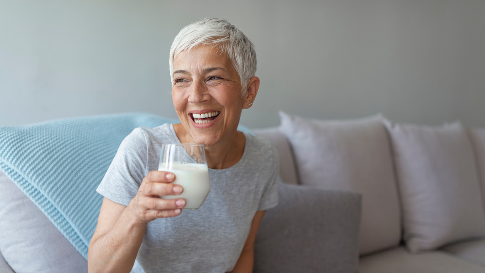 Senior woman drinking glass of milk