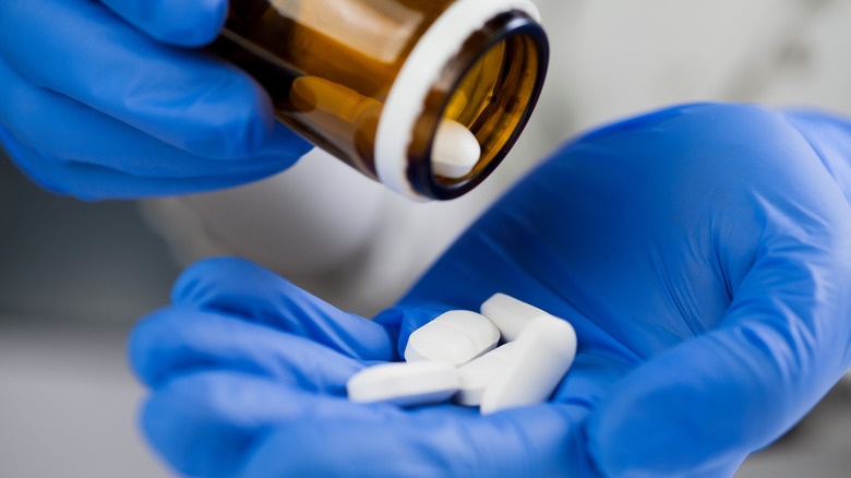 medical worker holding pills