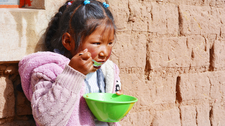 young indigenous girl eating