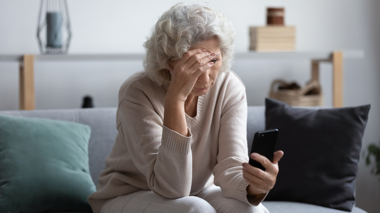 older woman looking at phone 