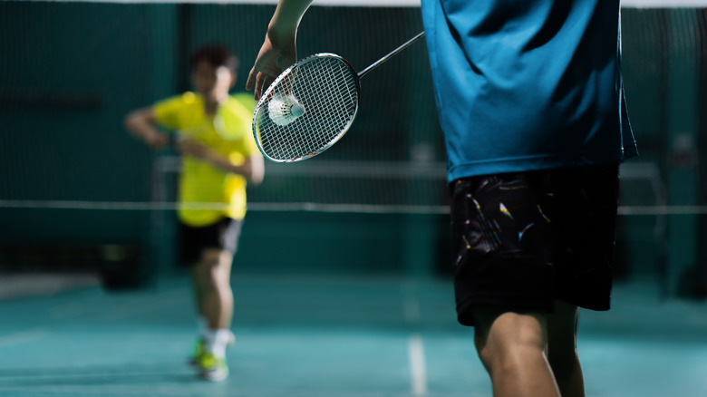 Two badminton players mid-game