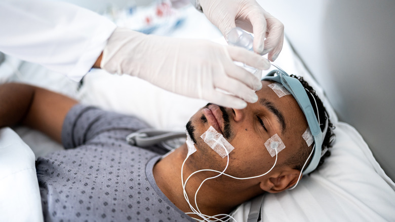 Patient in a hospital bed undergoing sleep study